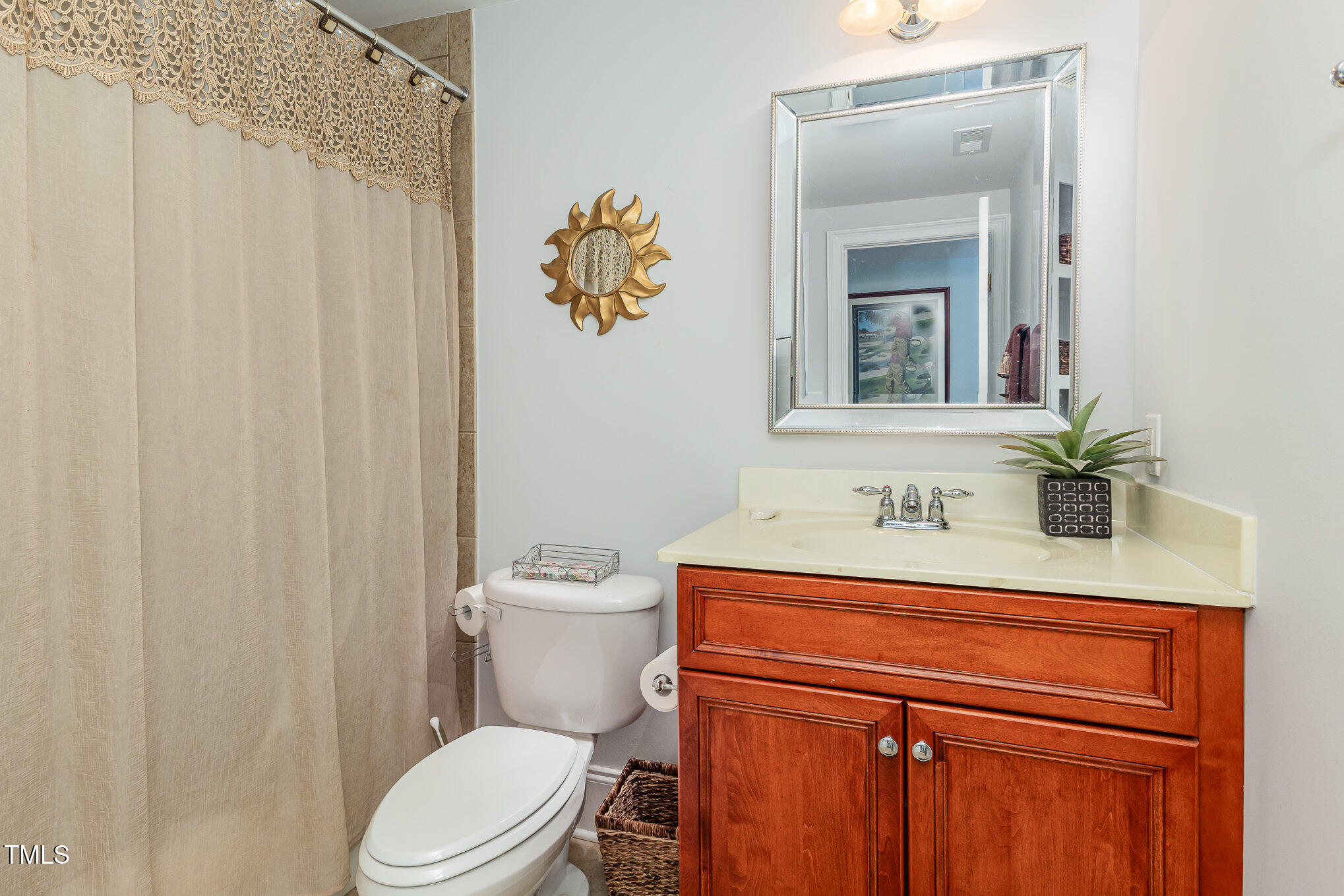 10841 Round Brook Circle Raleigh, NC 27617 - Photo 37 of 44 a bathroom with a toilet sink and mirror