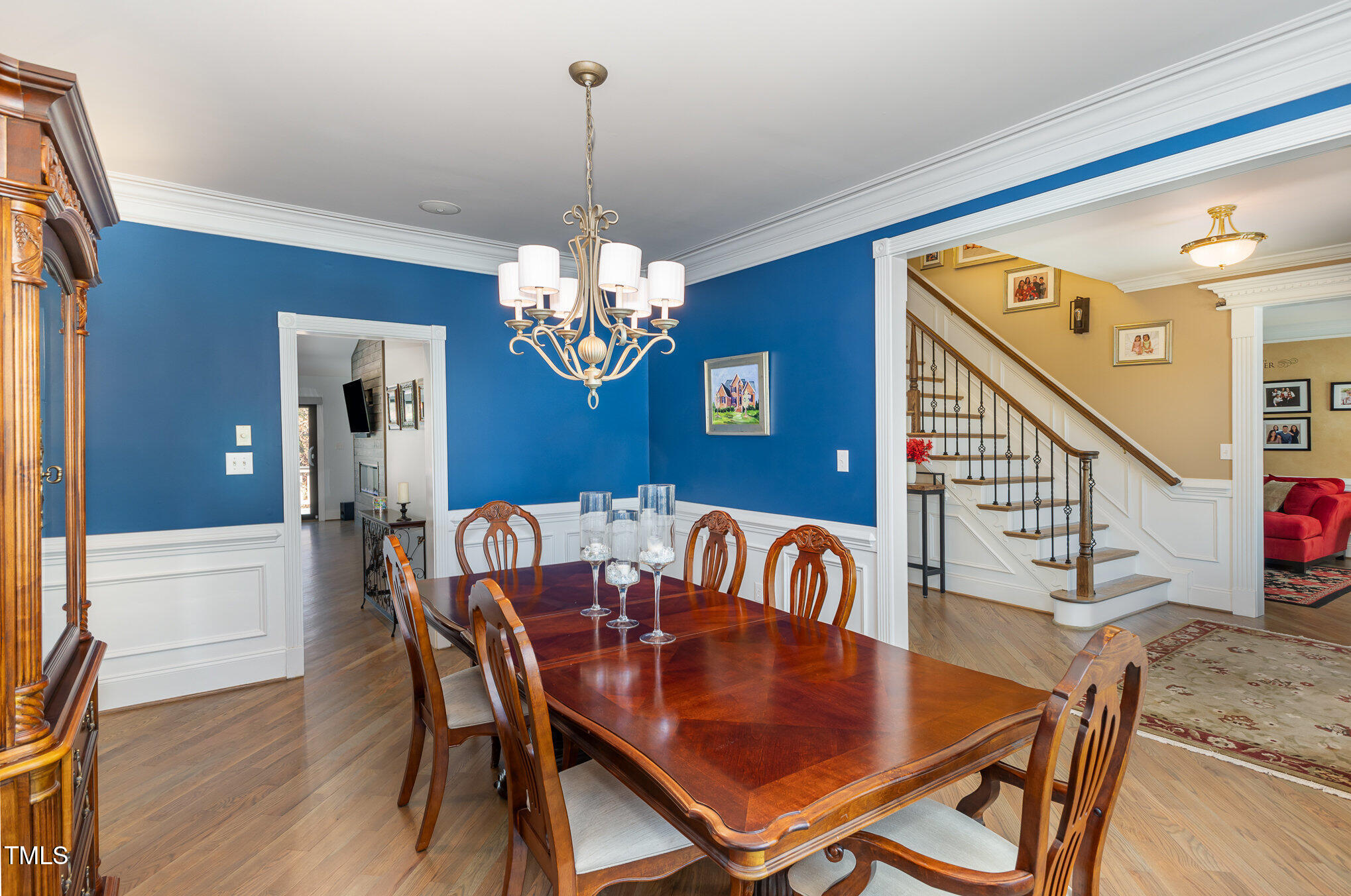 10841 Round Brook Circle Raleigh, NC 27617 - Photo 8 of 44 a view of a dining room with furniture a chandelier and wooden floor