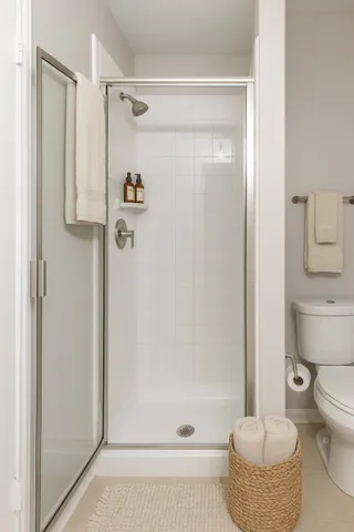 a bathroom with a shower a toilet and a sink