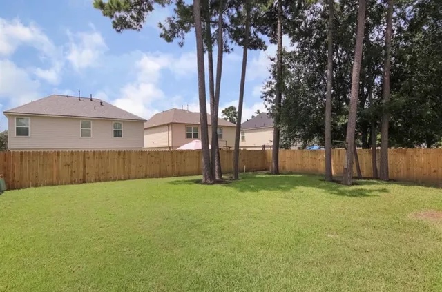 a backyard of a house with table and chairs