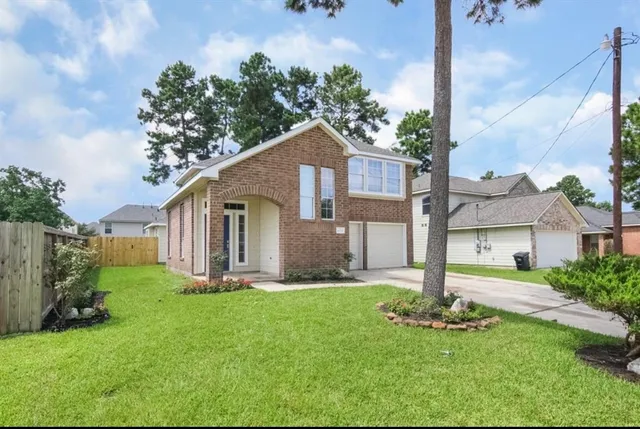 a front view of house with yard and green space