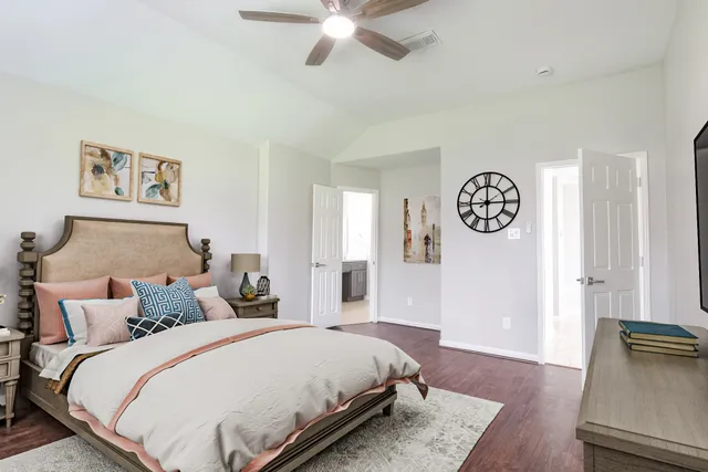 a bedroom with bed and wooden floor