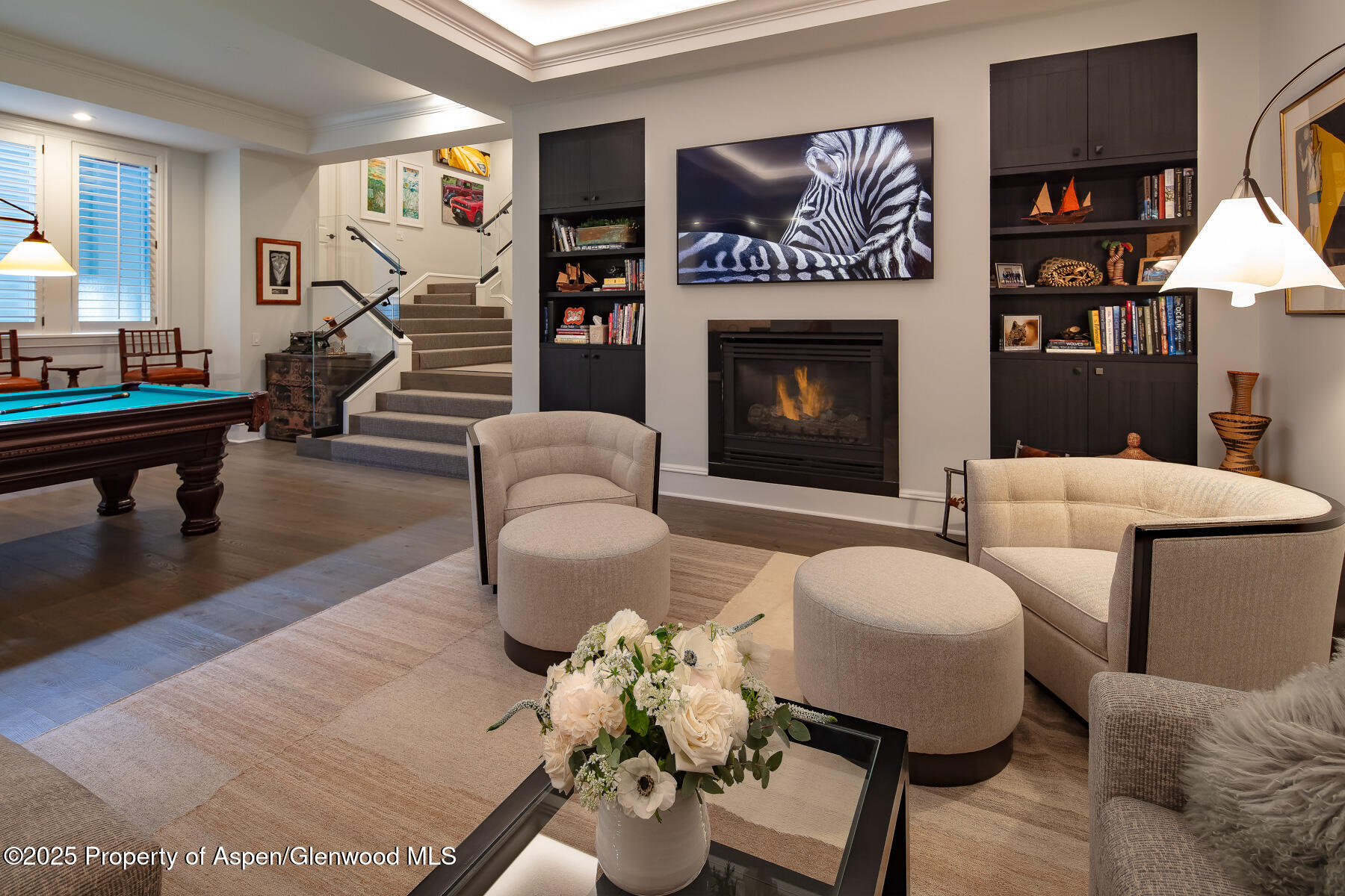 205 North 6th Street Aspen, CO 81611 - Photo 20 of 29 a living room with furniture a lamp and a fireplace