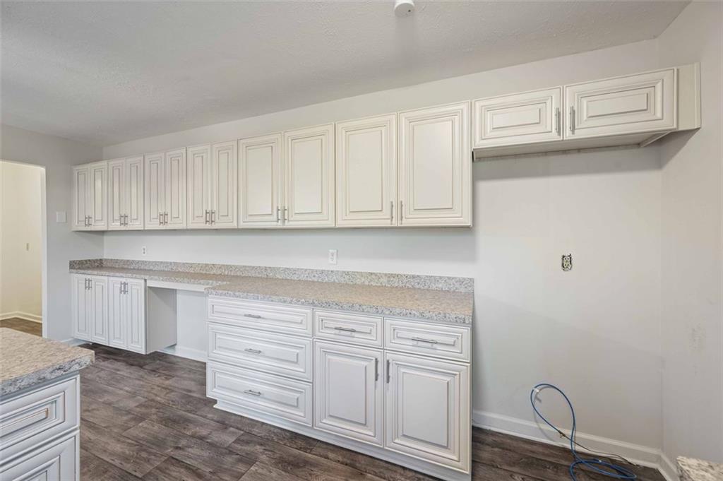 4166 Rue St Michel Stone Mountain, GA 30083 - Photo 15 of 31 a kitchen with granite countertop white cabinets and sink