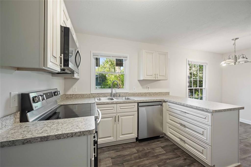 4166 Rue St Michel Stone Mountain, GA 30083 - Photo 16 of 31 a kitchen that has a sink a window and stainless steel appliances