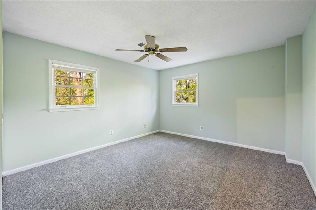 4166 Rue St Michel Stone Mountain, GA 30083 - Photo 27 of 31 an empty room with windows and fan