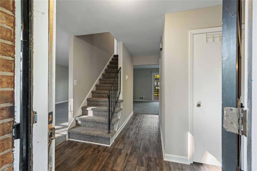 4166 Rue St Michel Stone Mountain, GA 30083 - Photo 6 of 31 a view of a hallway with wooden floor and entryway