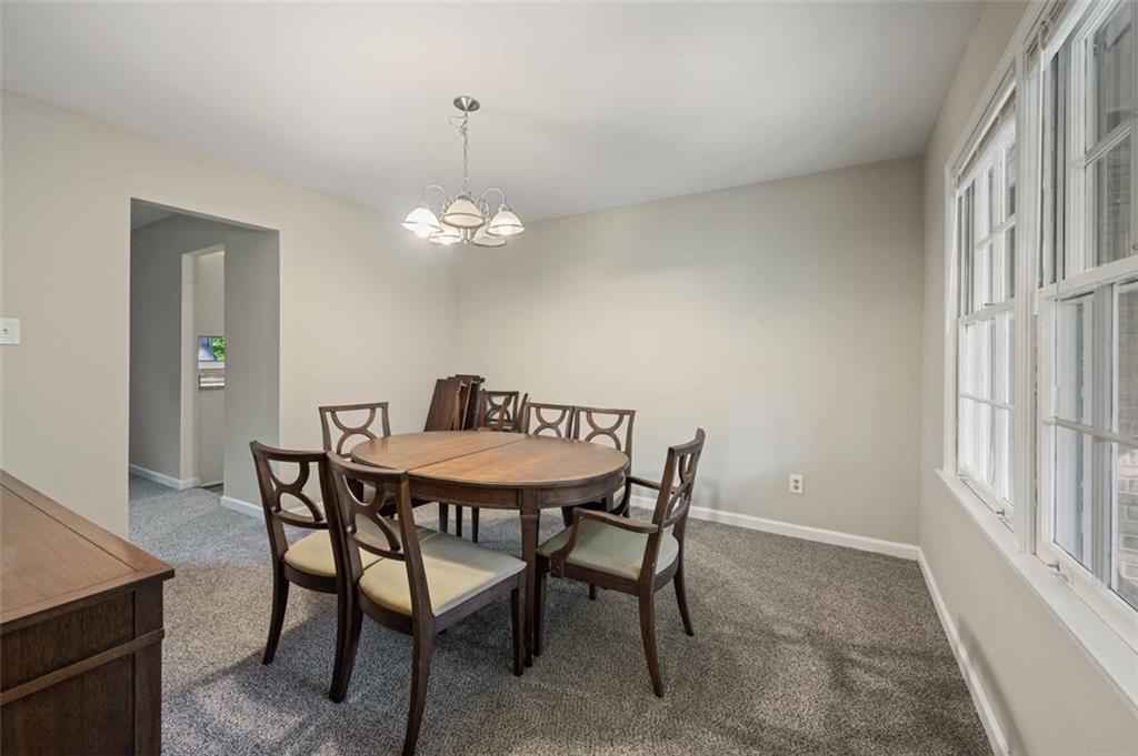 4166 Rue St Michel Stone Mountain, GA 30083 - Photo 10 of 31 a view of a dining room with furniture and chandelier