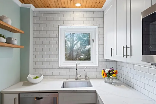 a bathroom with a sink a bathtub and a window