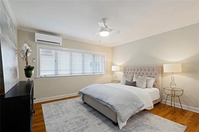 a bedroom with a large bed chandelier and a window