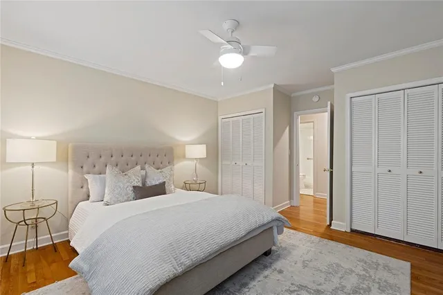 a spacious bedroom with a bed and a chandelier