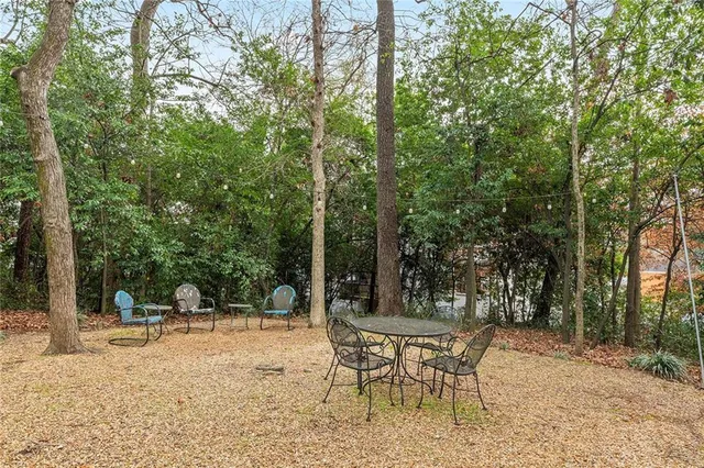 a swimming pool with a bench and trees
