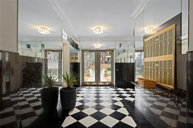 a view of entryway with a floor to ceiling window and potted plant