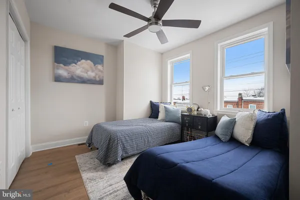 a bedroom with two beds and a painting