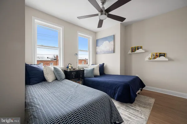 a bedroom with two beds and a chandelier
