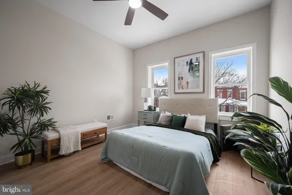 a bedroom with a bed and a potted plant