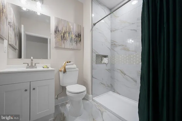 a bathroom with a sink toilet and shower