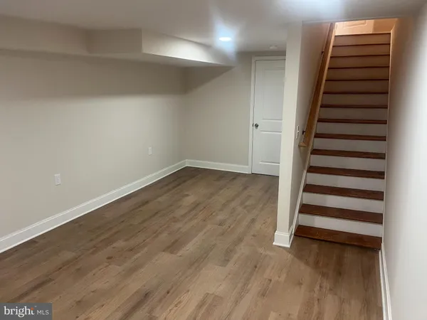wooden floor in an empty room with stairs
