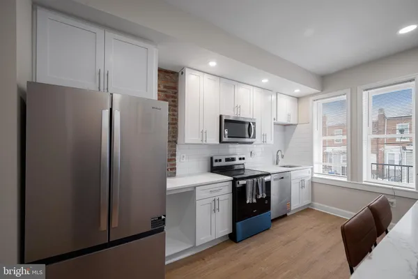 a kitchen with stainless steel appliances a refrigerator stove and sink