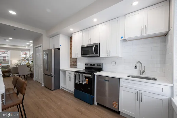 a kitchen with a sink cabinets and stainless steel appliances