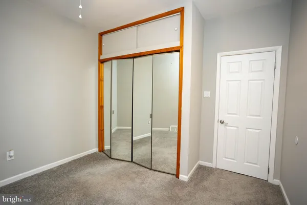 an empty room with sliding door and door