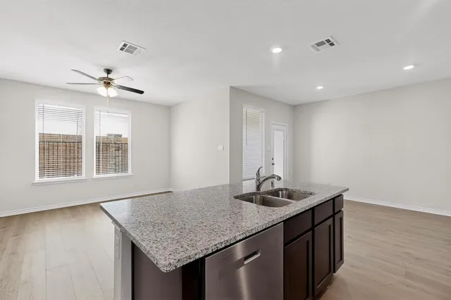a kitchen with granite countertop stainless steel appliances and wooden cabinets