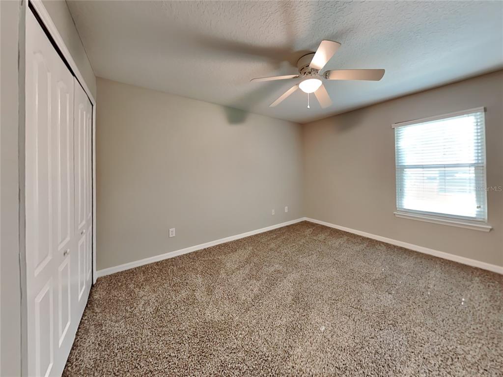 906 Summit Ash Court Deland, FL 32724 - Photo 13 of 19 an empty room with windows and fan