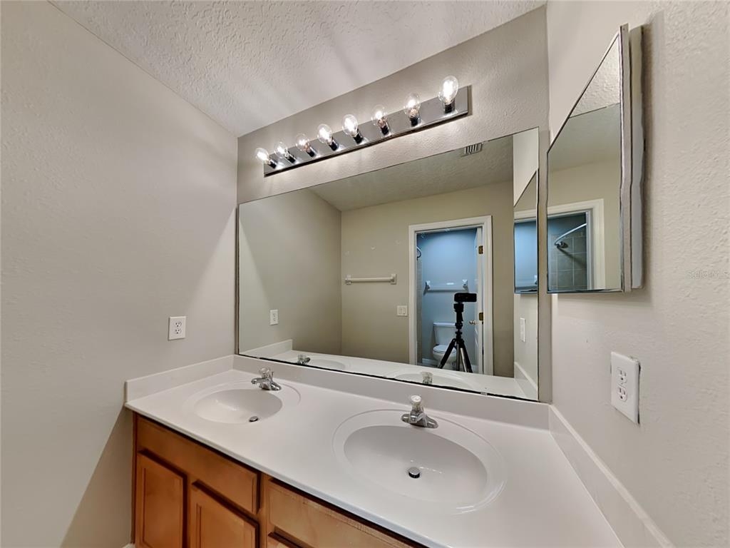 906 Summit Ash Court Deland, FL 32724 - Photo 16 of 19 a bathroom with a sink and a mirror