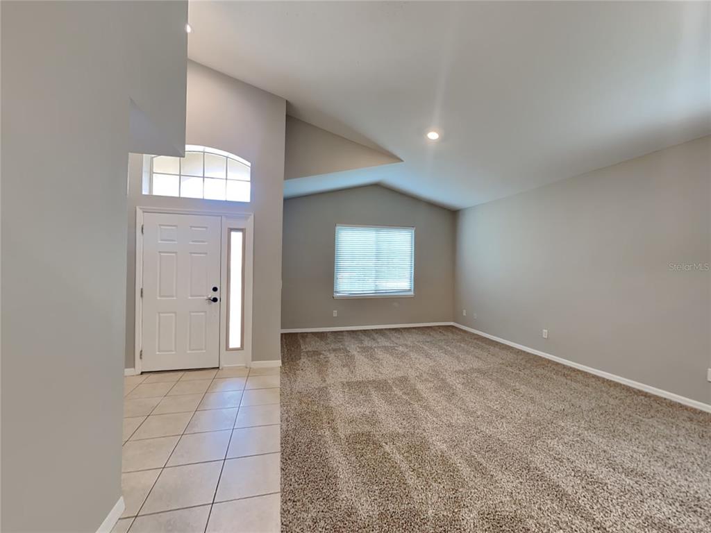 906 Summit Ash Court Deland, FL 32724 - Photo 2 of 19 an empty room with windows and entrance