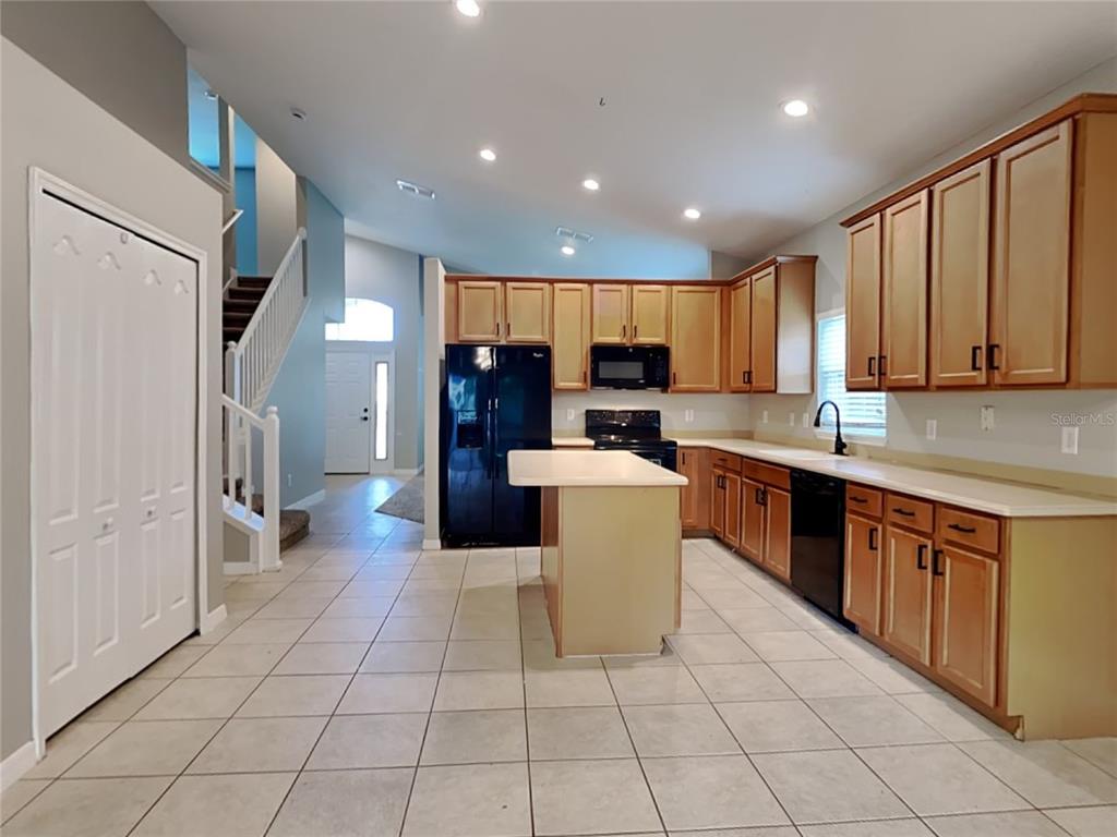 906 Summit Ash Court Deland, FL 32724 - Photo 6 of 19 a large kitchen with stainless steel appliances granite countertop a refrigerator and a stove top oven