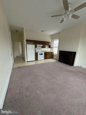 a view of a kitchen with furniture and a ceiling fan