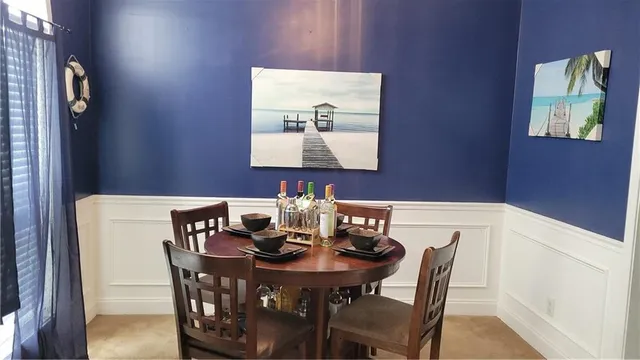 a view of a dining room with furniture and wooden floor