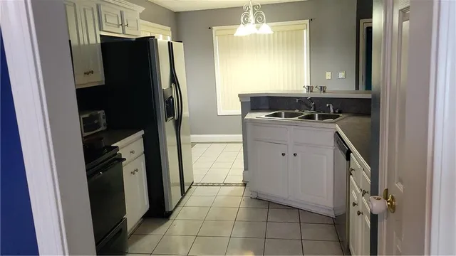 a kitchen with a refrigerator and a stove