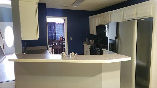 a kitchen with stainless steel appliances a refrigerator and a sink