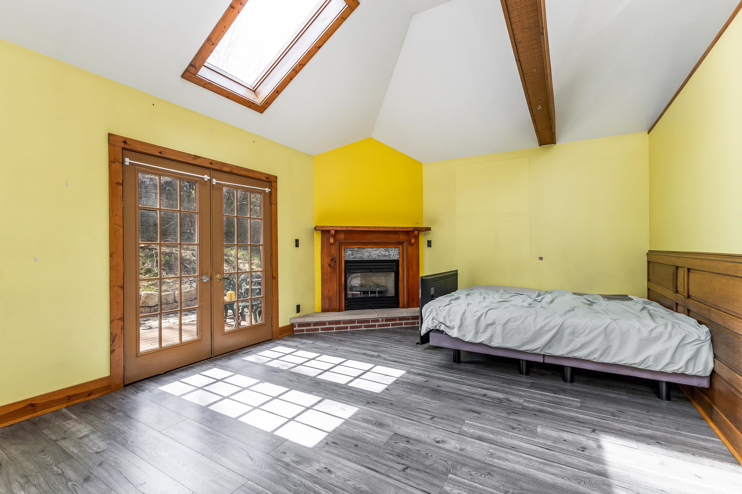 330 Spring Street Galena, IL 61036 - Photo 12 of 27 a bedroom with a bed and a fireplace