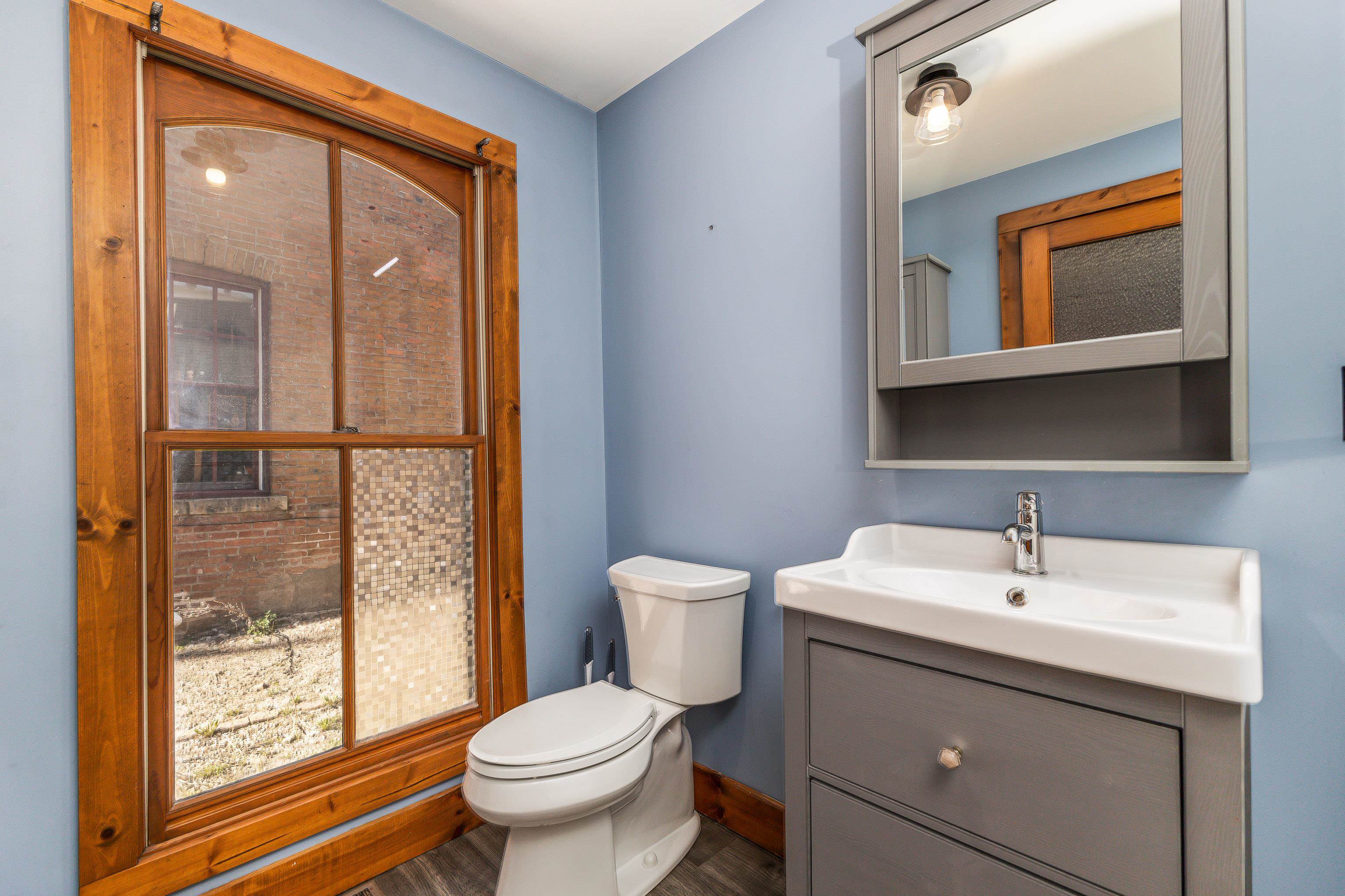 330 Spring Street Galena, IL 61036 - Photo 17 of 27 a bathroom with a toilet a sink and a mirror
