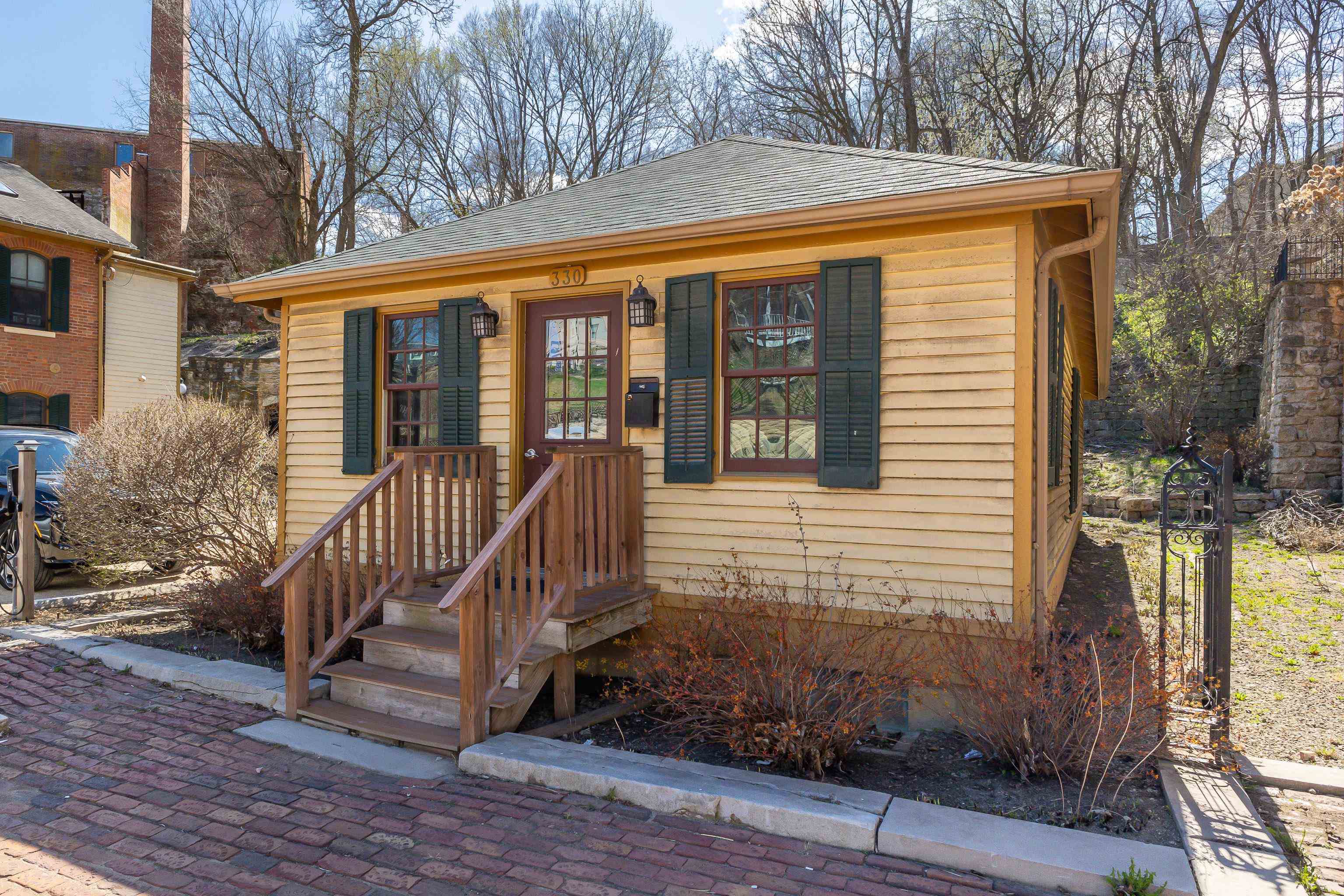 330 Spring Street Galena, IL 61036 - Photo 7 of 27 a view of a house with a large window and wooden fence
