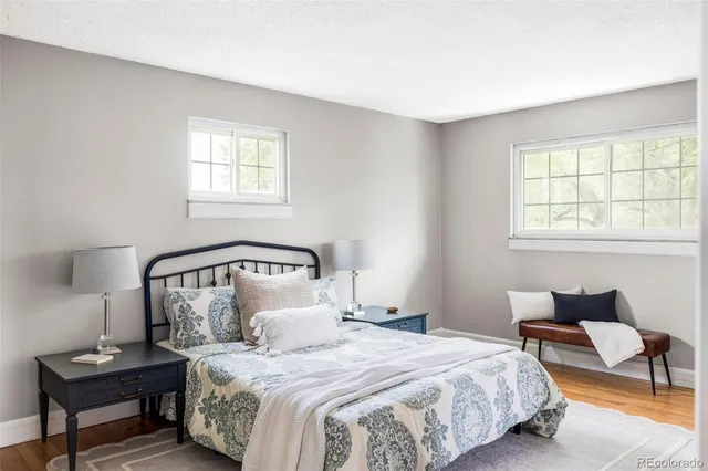 a bedroom with a bed a mirror and a window