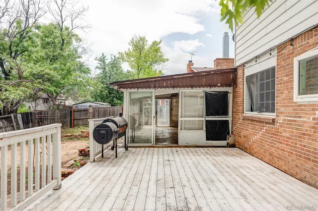 a view of a deck with wooden floor and barbeque oven