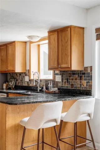 a kitchen with stainless steel appliances granite countertop a sink and a white cabinets