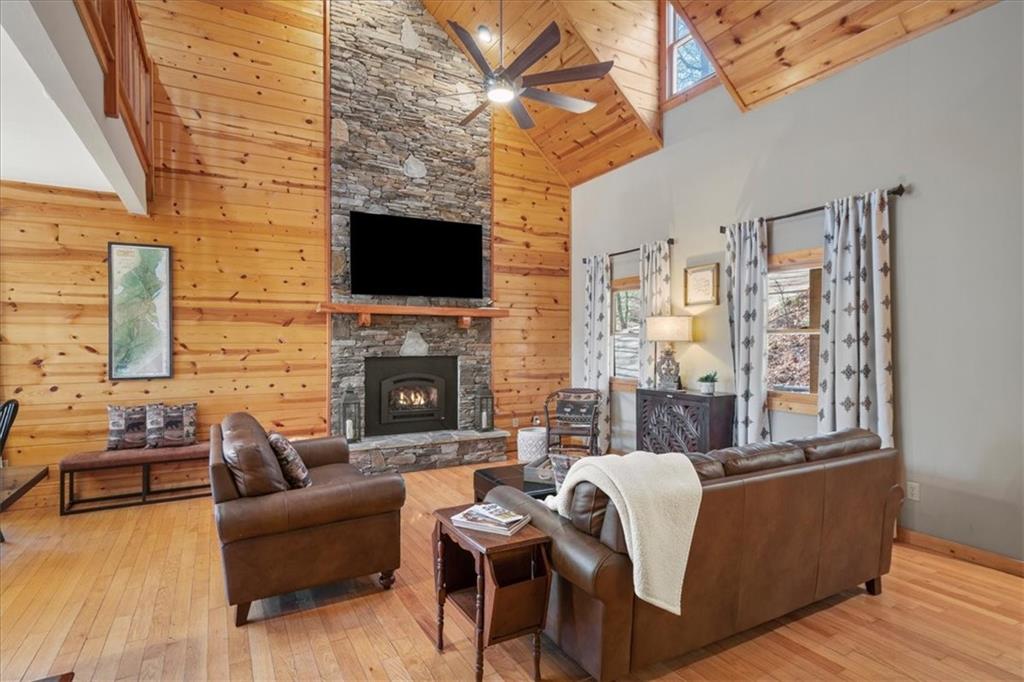 411 Gunite Circle Ellijay, GA 30540 - Photo 12 of 81 a living room with furniture a flat screen tv and a fireplace