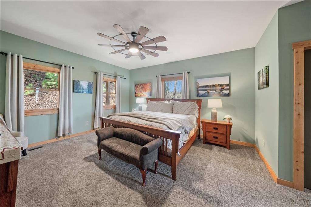 411 Gunite Circle Ellijay, GA 30540 - Photo 16 of 81 a bedroom with a bed and a chandelier