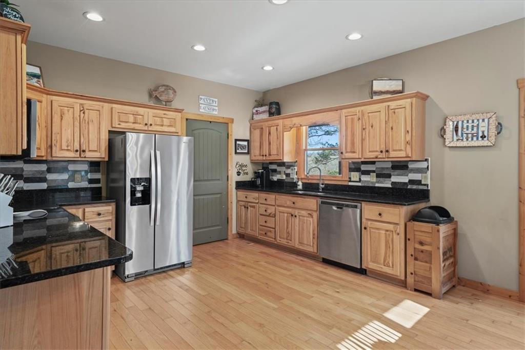 411 Gunite Circle Ellijay, GA 30540 - Photo 26 of 81 a kitchen with granite countertop a refrigerator and a stove top oven