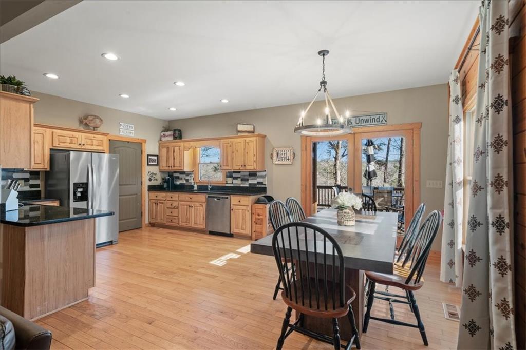 411 Gunite Circle Ellijay, GA 30540 - Photo 27 of 81 a view of a dining room and livingroom with furniture wooden floor a chandelier