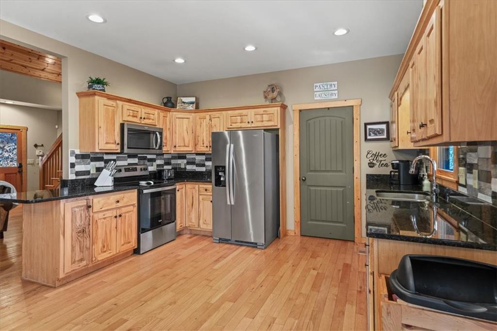 411 Gunite Circle Ellijay, GA 30540 - Photo 28 of 81 a kitchen with granite countertop a refrigerator stove and sink