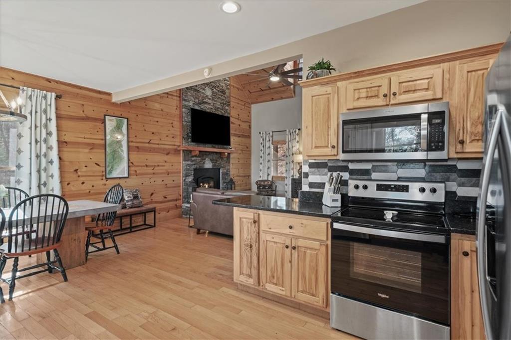 411 Gunite Circle Ellijay, GA 30540 - Photo 29 of 81 a kitchen with stainless steel appliances a stove sink microwave and cabinets