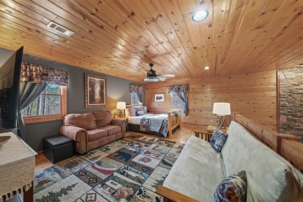 411 Gunite Circle Ellijay, GA 30540 - Photo 38 of 81 a living room with furniture a rug and a chandelier