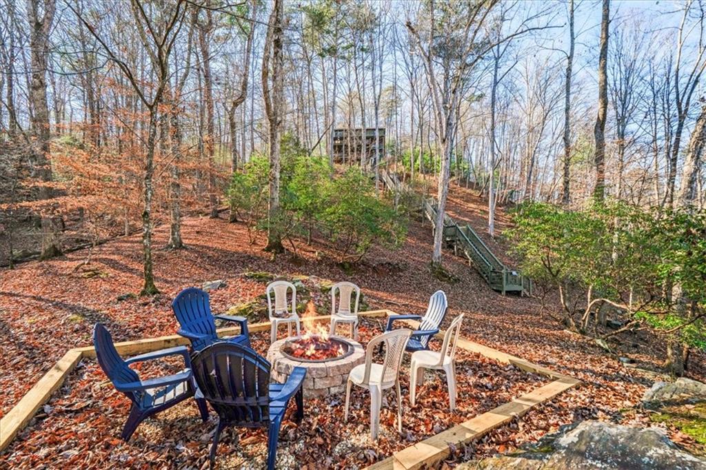 411 Gunite Circle Ellijay, GA 30540 - Photo 72 of 81 a view of a chairs and table in backyard