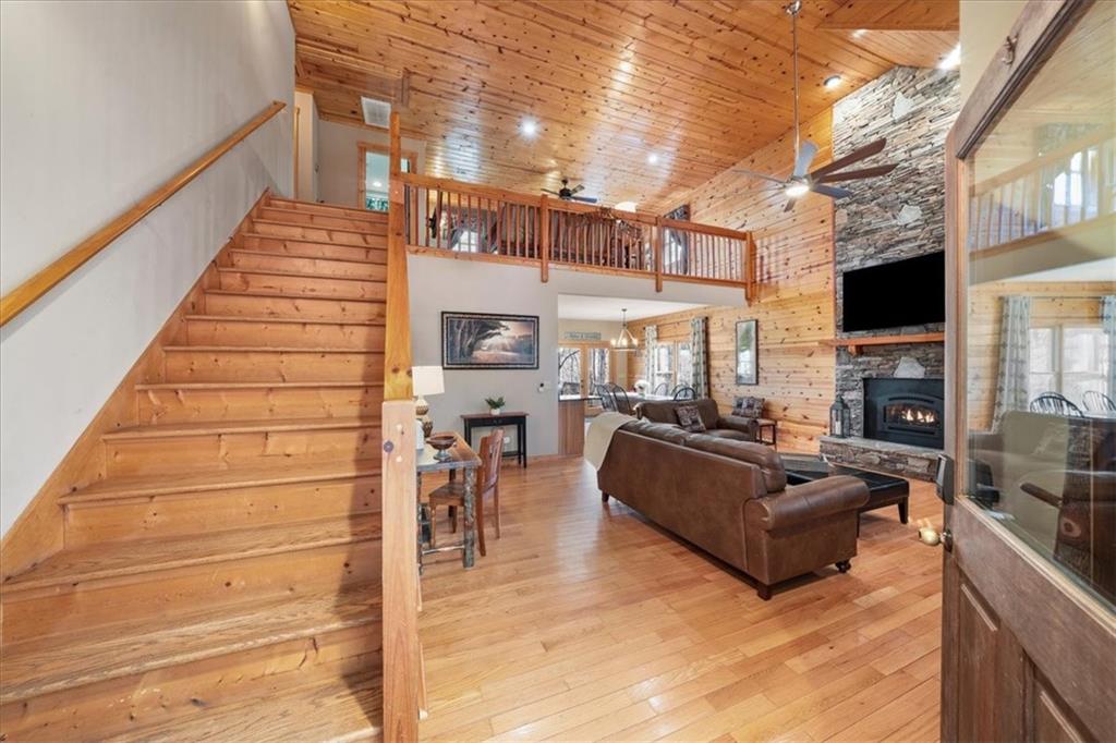 411 Gunite Circle Ellijay, GA 30540 - Photo 8 of 81 a living room with furniture a fireplace and a floor to ceiling window