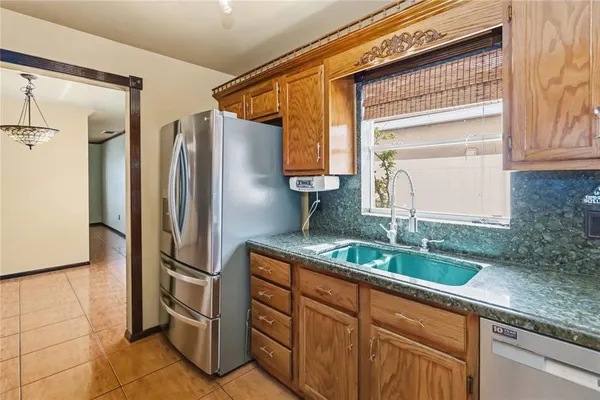 a kitchen with stainless steel appliances granite countertop a refrigerator and a sink